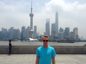Perryman stands in front of  skyline in Shanghai, China.